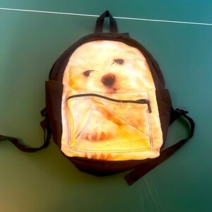 Small backpack with puppy print and small pocket in the front